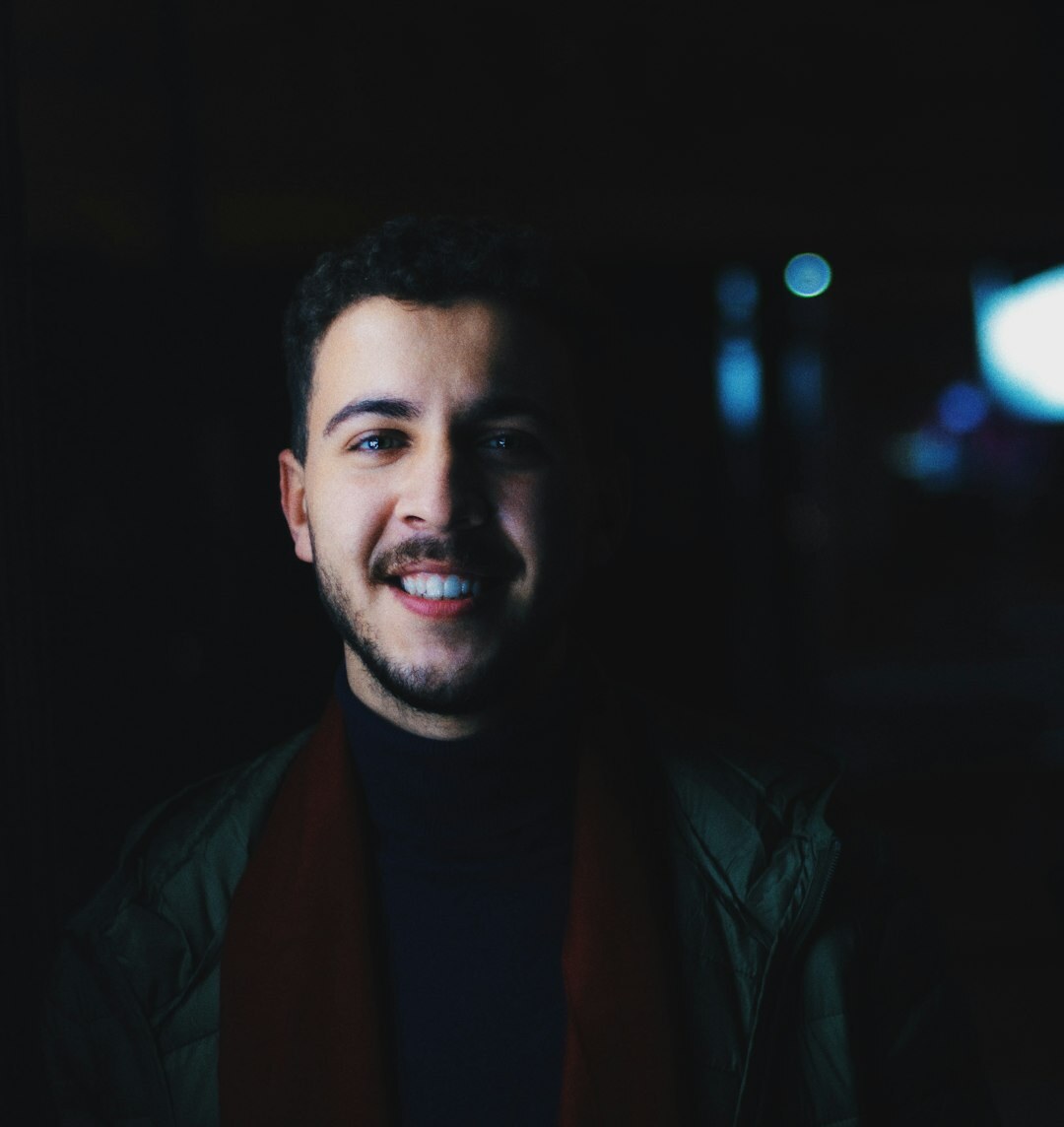 Studio portrait of a Brazilian man with a beard smiling confidently